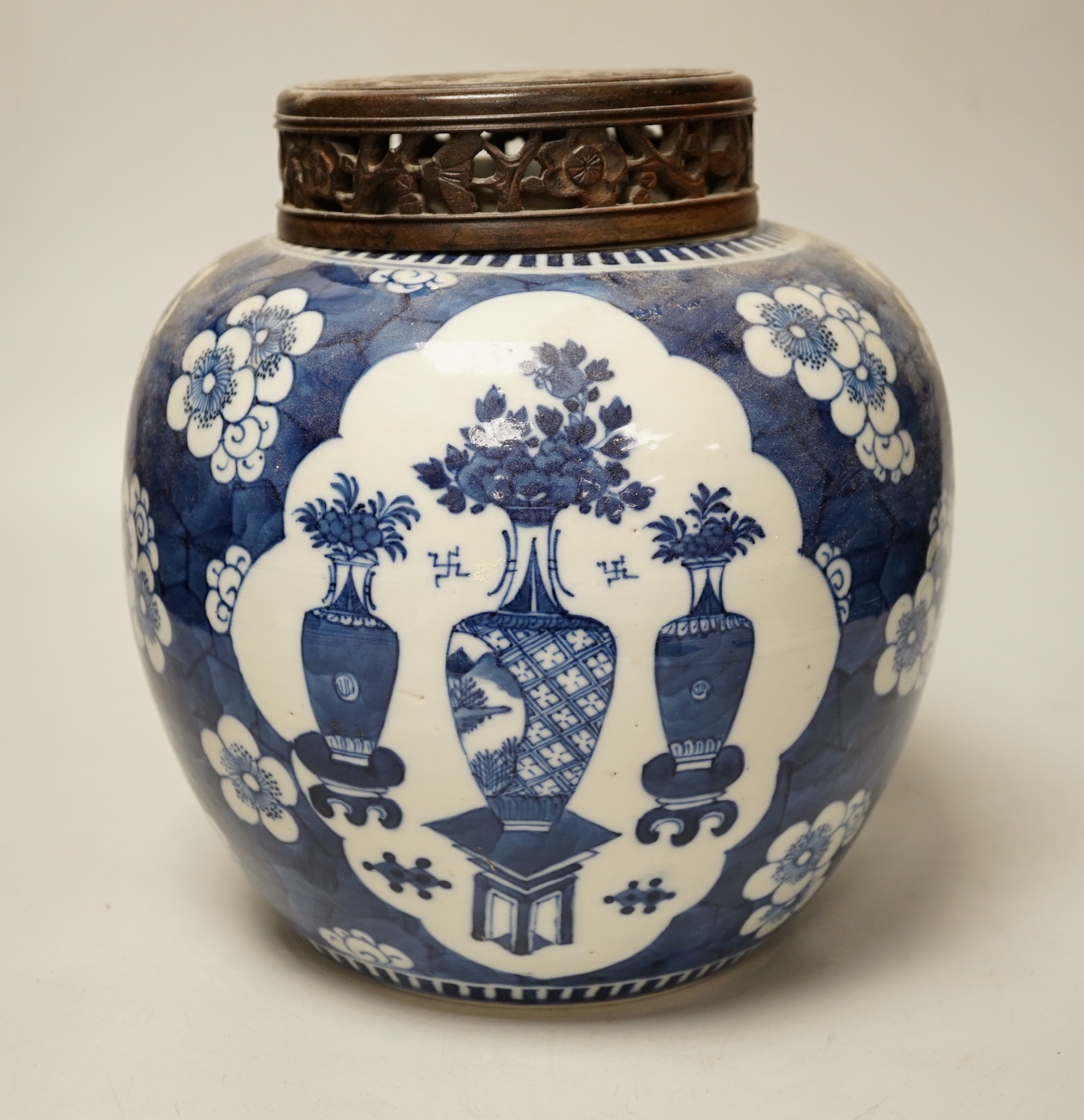 A 19th century Chinese blue and white prunus jar and carved wood cover, 24cm